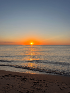 The sun setting over the water.