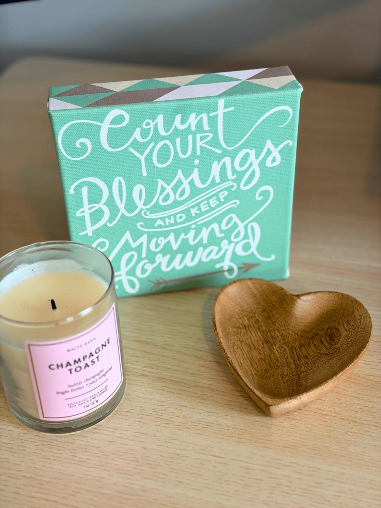 Ongoing SEO and content strategy support represented by word art, a candle, and a wooden heart-shaped dish.